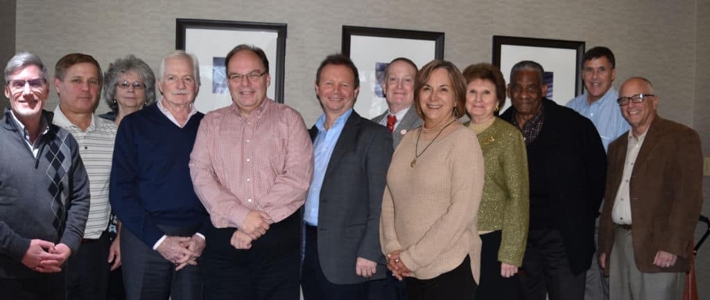 Group of smiling people in a meeting room.